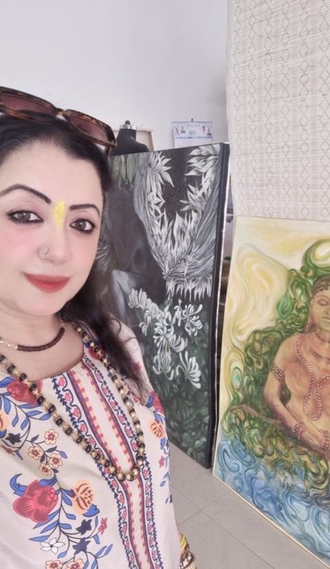Madhvi Oberoi Kapur, professional tarot reader, numerologist, and spiritual healer standing with Buddha paintings representing her spiritual journey